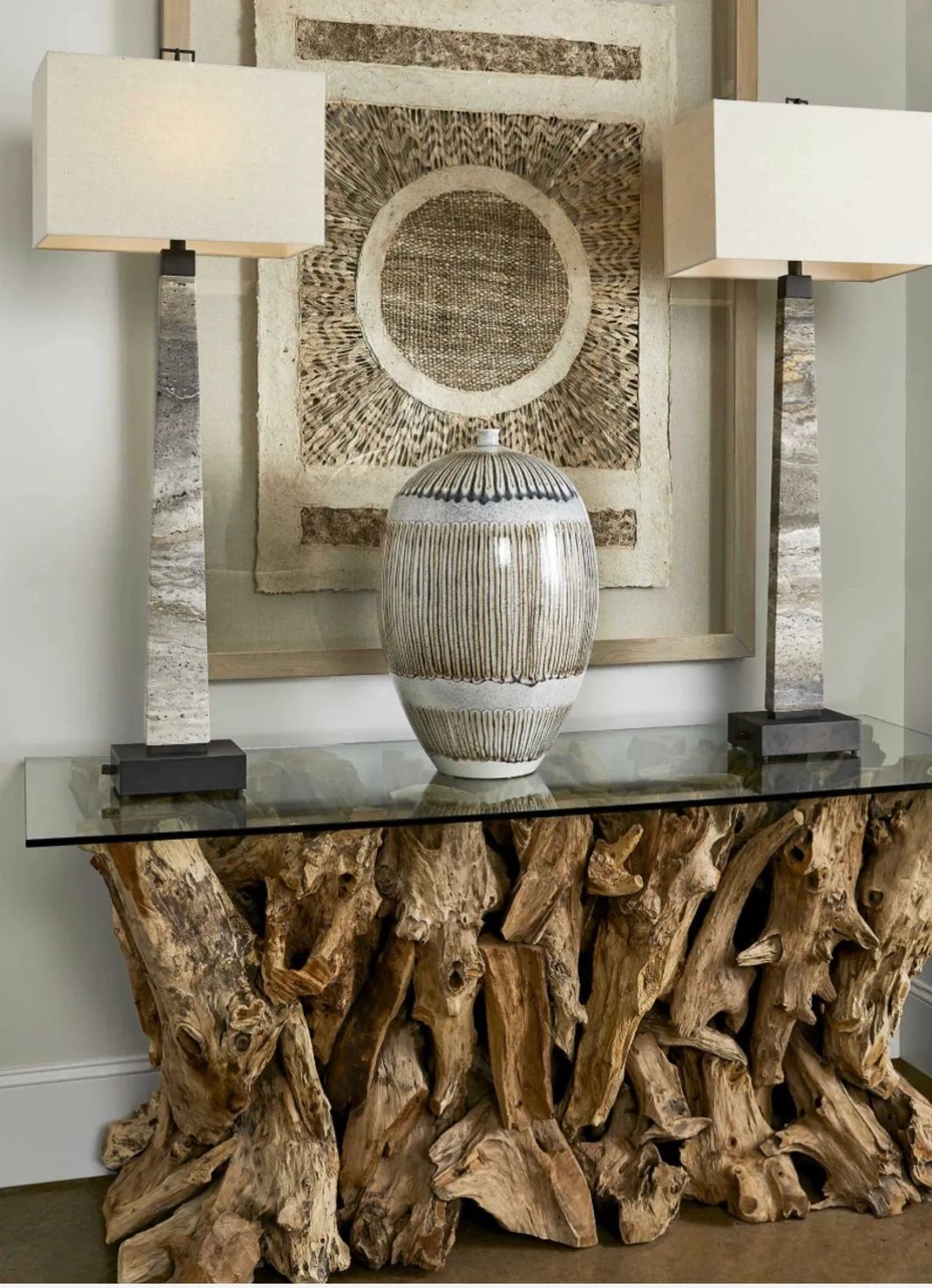 Uttermost Natural, unfinished teak wood sculpted into a dramatic table with a thick, clear glass top