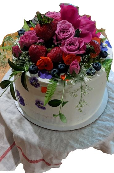 A cake with fruits and flowers