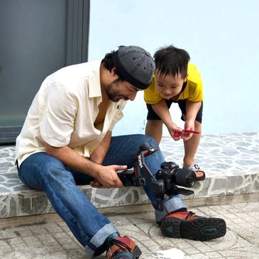 Man and boy examining a camera together.