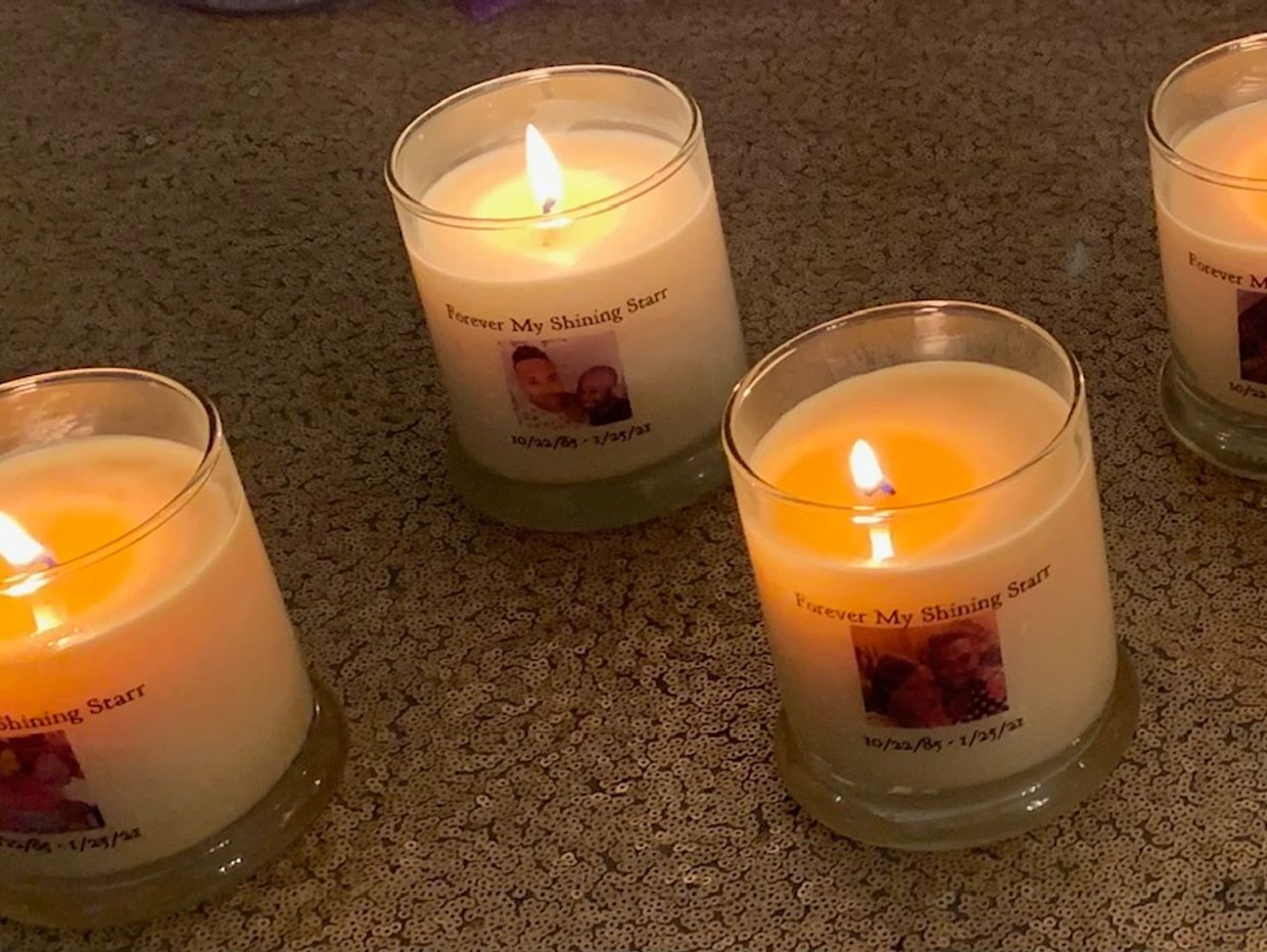 Lit memorial candles labeled 'Forever My Shining Starr' with dates and photos.