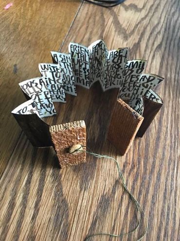 Accordion book with walnut ink and tree bark.