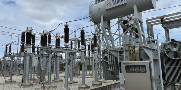Electrical substation with transformers and power lines.