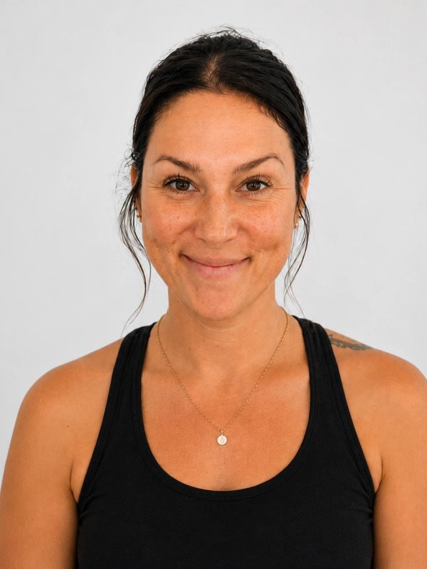 Smiling woman with dark hair in a black tank top.