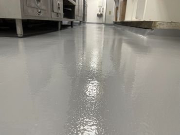 Solid color grey epoxy flooring in commercial kitchen