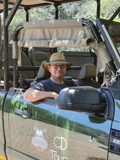 Barry sitting in a CD tours safari truck