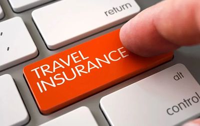 person clicking a "travel insurance" button on their computer