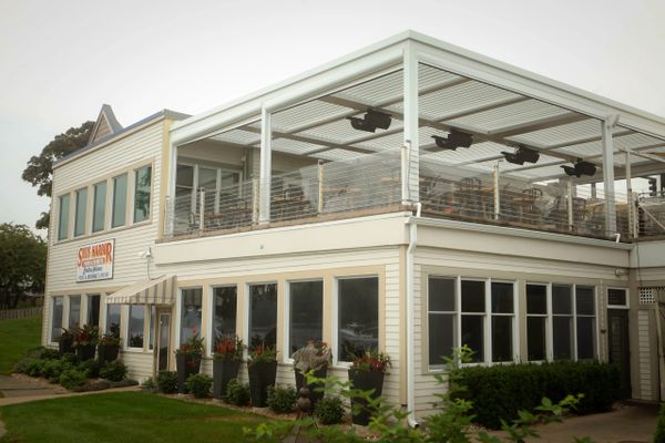 powered pergola over outdoor dining space