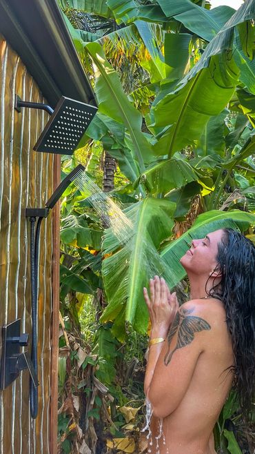 a woman taking shower outside