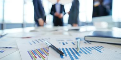 Close-up of financial charts and professionals representing financial services.
