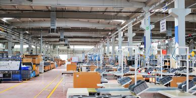 Modern factory floor with machinery showcasing manufacturing and production efficiency.