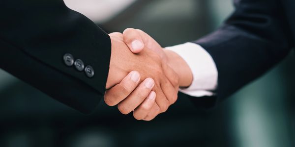 Close-up handshake representing partnership and sustainable growth.