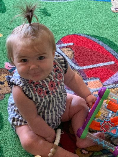 A little sweetheart playing with a toy at daycare