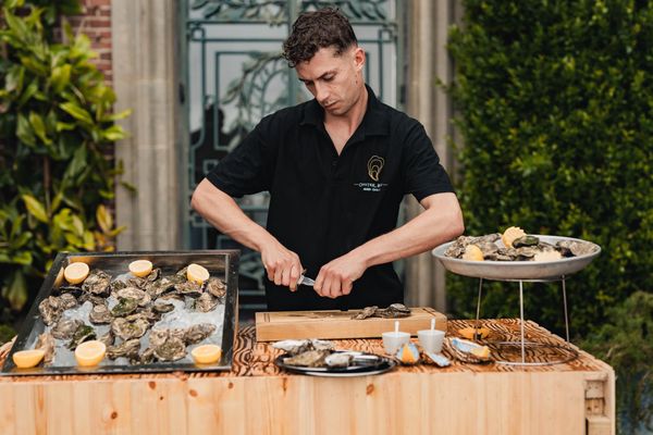 Oyster Buoys Mobile Event Caterer opening oysters at your next event.