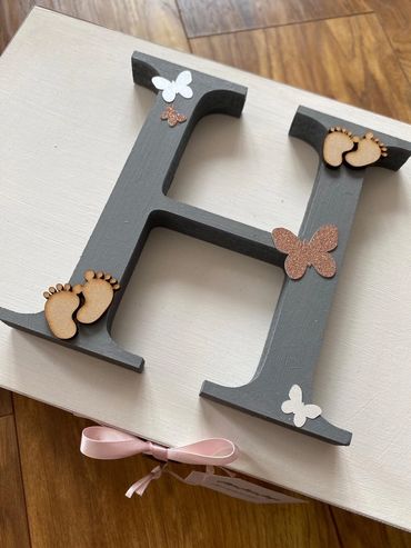 White wooden Memory Box with large, grey, wooden, letter initial, baby feet and butterfly embellishm
