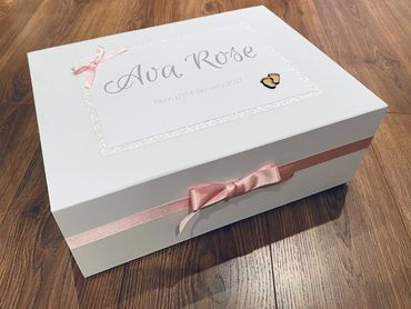 White Memory Box with wooden baby feet embellishment and Pink Ribbons & Bows, for a new born baby.