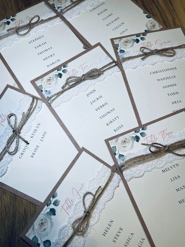 Wedding Seating Plan Cards, with white rose design and white lace & rustic twine decorations.
