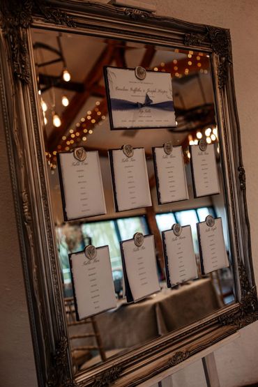 Wedding Table/Seating Plan with blue Ribbons mounted with wax seals on a mirrored Silver Frame.