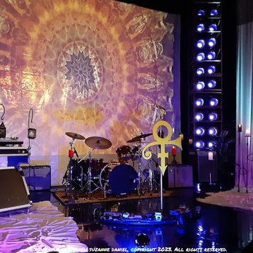 In Paisley Park After Dark Club Love Symbol on stage with kaleidoscope background