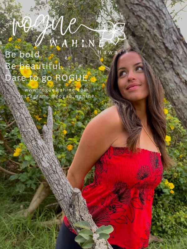 Woman in red top posing by a tree with yellow flowers.