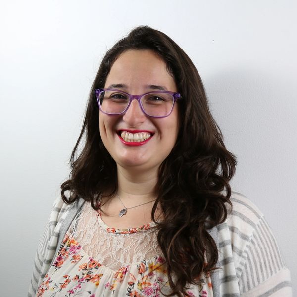 headshot of a latinx woman with glasses and a cardigan