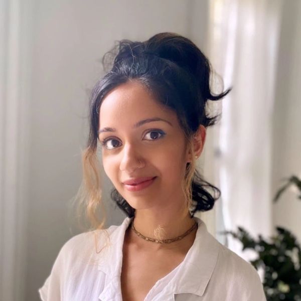 headshot of south east asian woman with a high ponytail