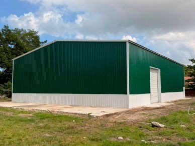 Green and white metal warehouse building.