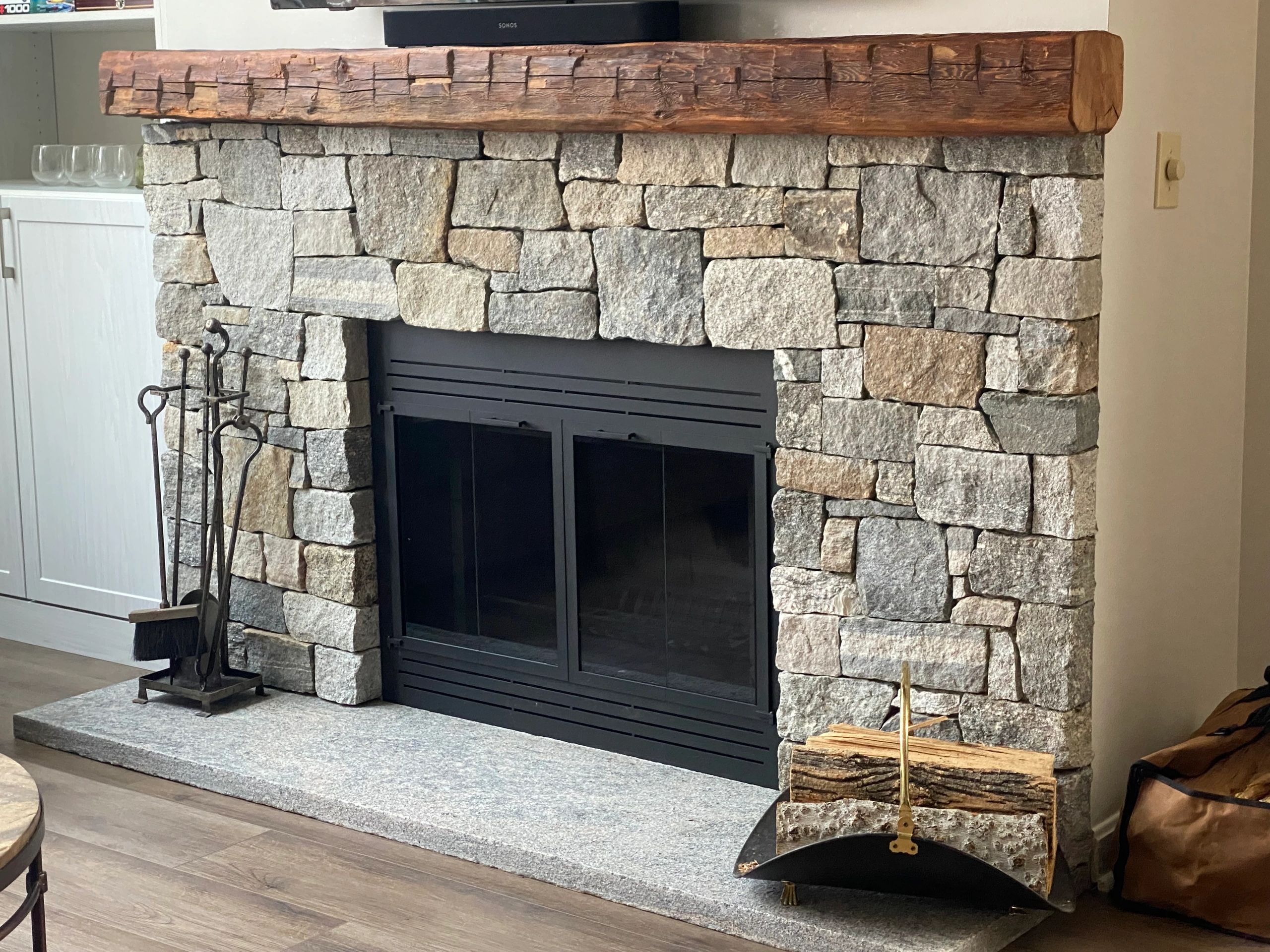 building stone tile fireplace with single shelf