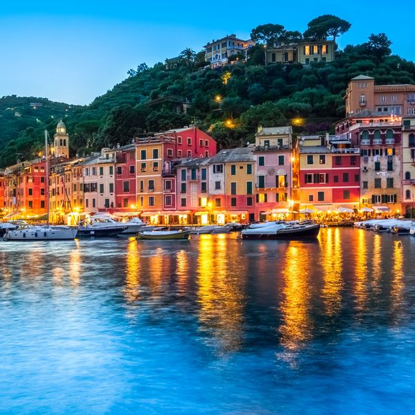 Positano, Italy
Colorful waterfront buildings and boats reflecting on calm water at dusk.