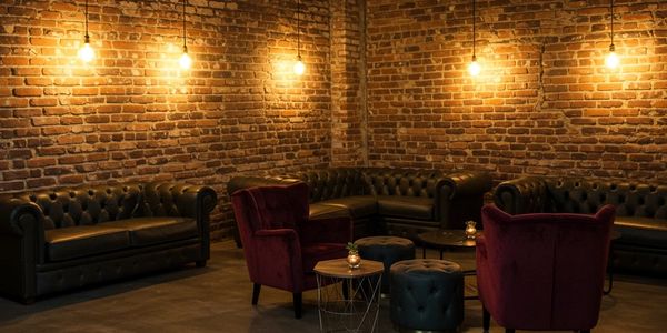 Cozy lounge with exposed brick walls and warm lighting.