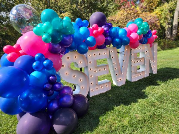 outdoor Jewel tone balloons garland on Marquee letters