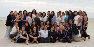 Group of women gathered on the beach.