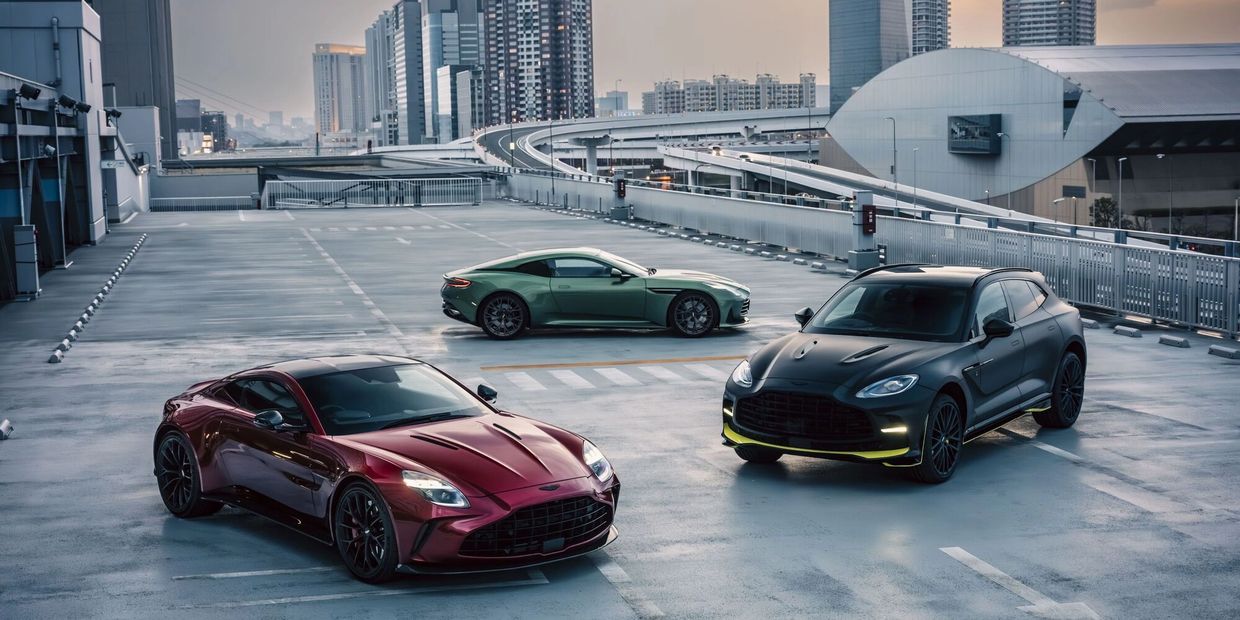 Three luxury sports cars parked on an urban rooftop.