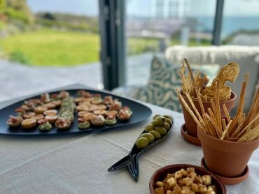Appetizers arranged on a table with a garden view.