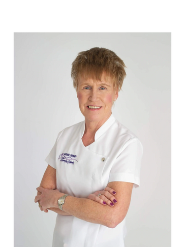 A profile photo of Joan Marshall Massage Therapist in her work tunic