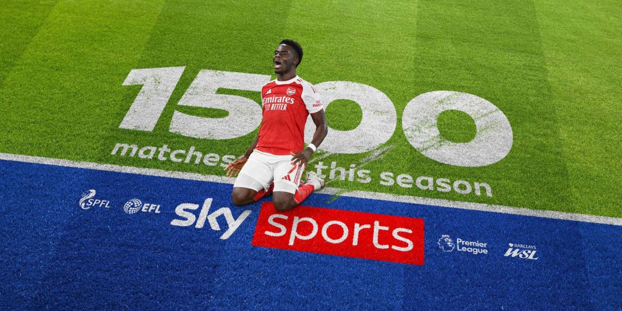 Football player celebrating 1500 matches milestone on field.