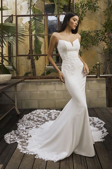 Elegant white wedding dress with lace train.