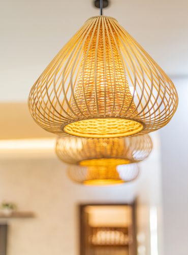 Woven pendant lamps emitting warm light in a modern interior.