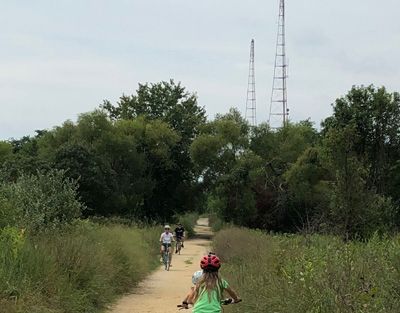 Walking and running trail with people riding bikes at Greenbury Point.