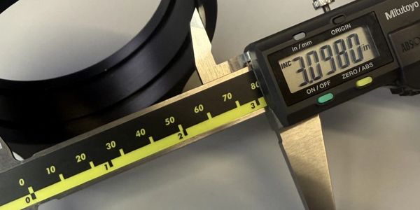 Digital caliper measuring an object with a reading of 30.980 mm.