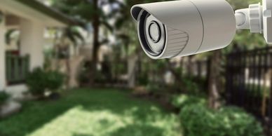 Outdoor security camera monitoring a residential garden area.