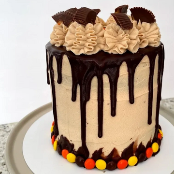 3-6in layers of decadent chocolate cake lined with PB buttercream covered w/ milk chocolate ganache