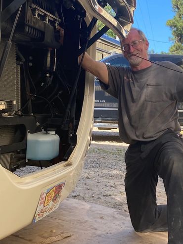 Scott checking the oil level on a motorhome.