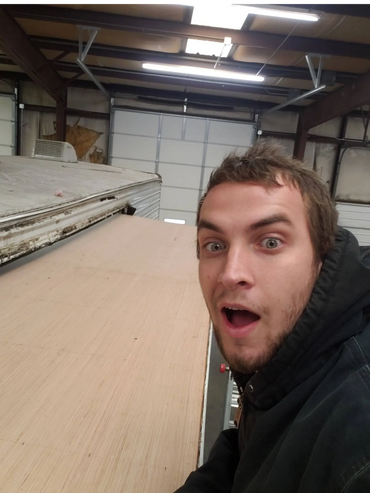 Alex installing a roof on a camper's slide.