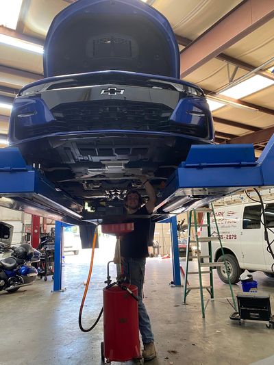 Alex performing oil change on a 2019 Chevrolet Camaro SS.
