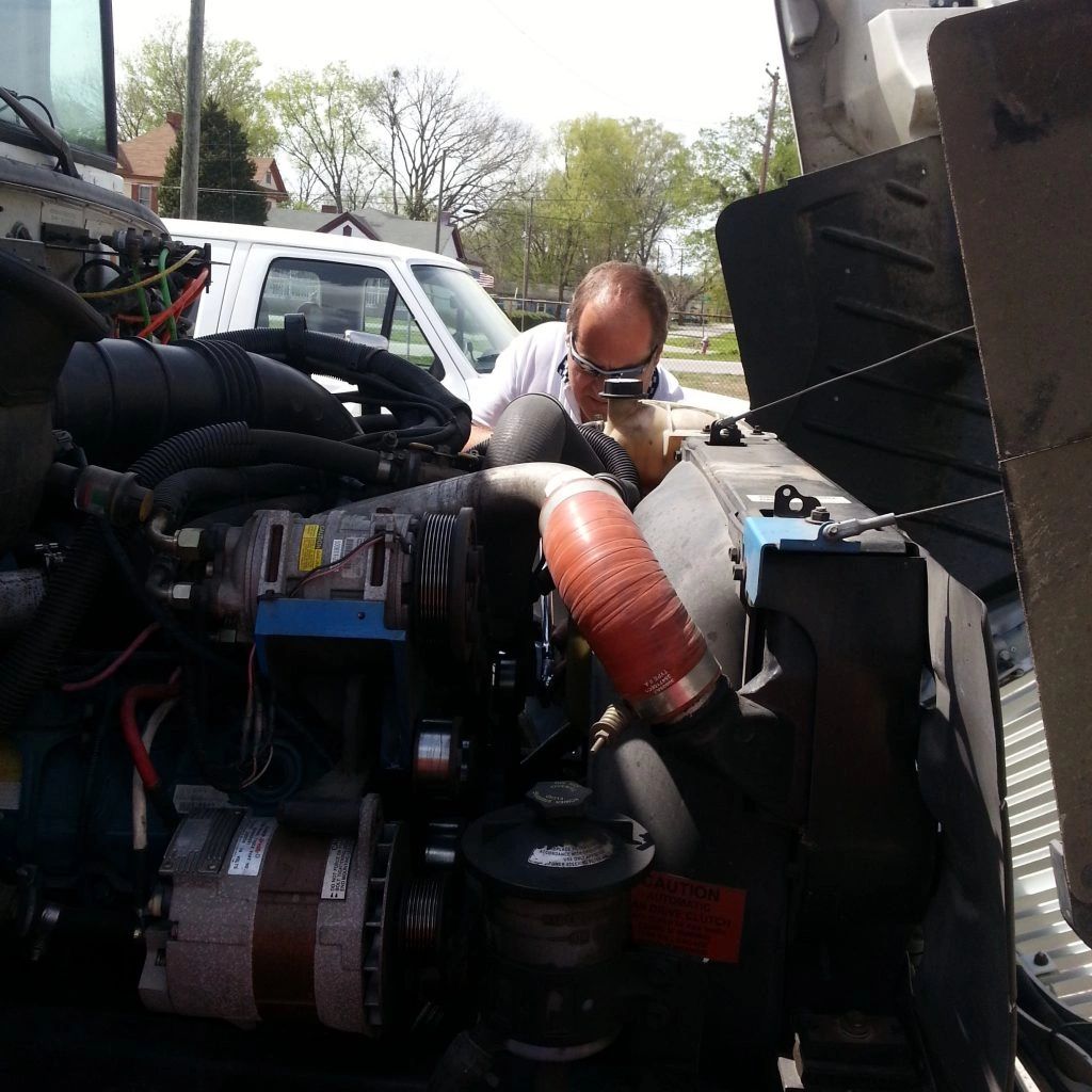Mark repairing a International bus.