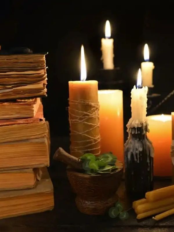 Lit candles and ritual tools, set for online spells and remote spiritual work by James