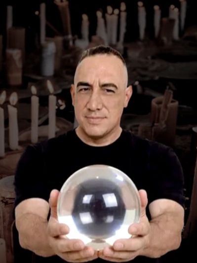James with crystal ball ready to perform spiritual psychic readings.