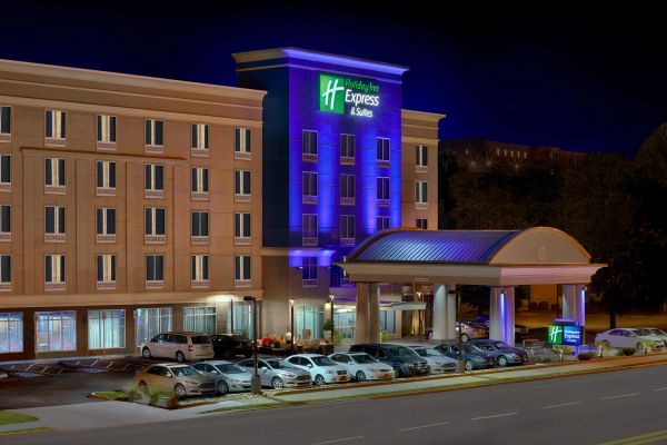 Holiday Inn Express & Suites hotel building lit up at night.