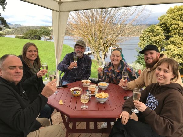 Huon Valley Road Trip - Huon River Cruises - a group having a wine tasting before their cruise