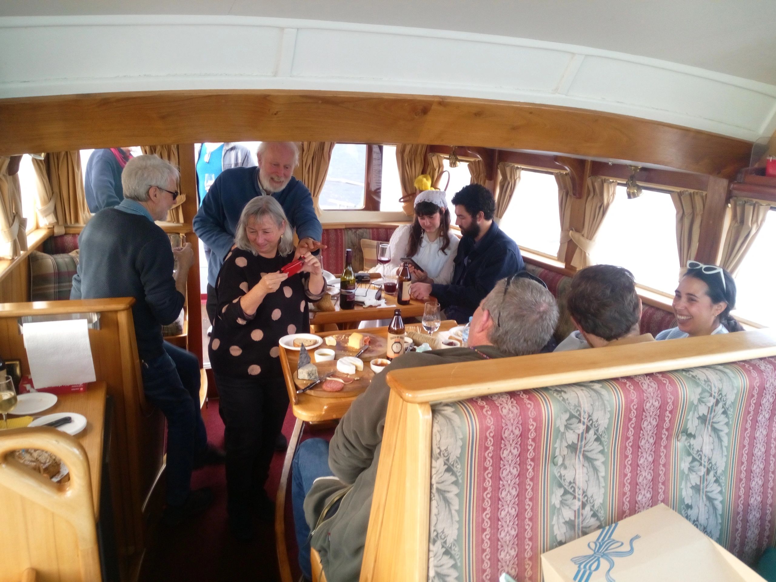 Standard Charter - Huon River Cruises - People enjoying the comfortable cabin of LaDrone.